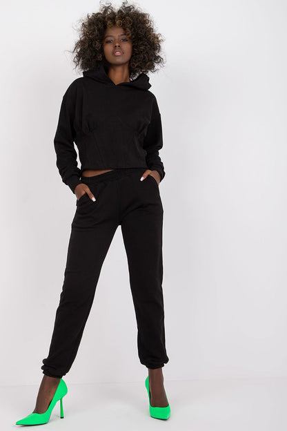 Luxury Ex Moda Cotton-Blend Sweatshirt Set with Corset Insert & Elastic Waist Pants, featuring a model in an elegant black hoodie with matching pants, accentuated with striking green high heels for a luxury look.
