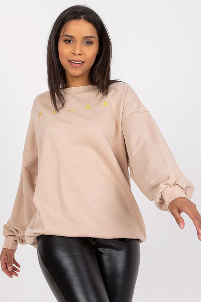 Sleek Ex Moda Women’s Long Sleeve Blouse with Round Neckline and Decorative Embroidery, featuring a lively model in a dynamic pose, ideal for upscale casual outfits.
