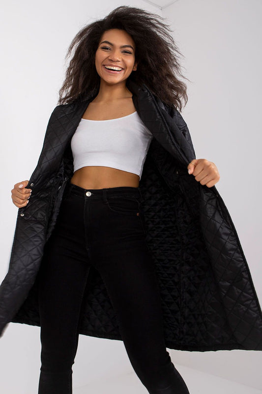 Radiant model enjoying the moment in the Ex Moda Quilted Long Sleeve Coat in 100% Polyester, with a stylish cropped top and black jeans, illuminated by her cheerful smile.