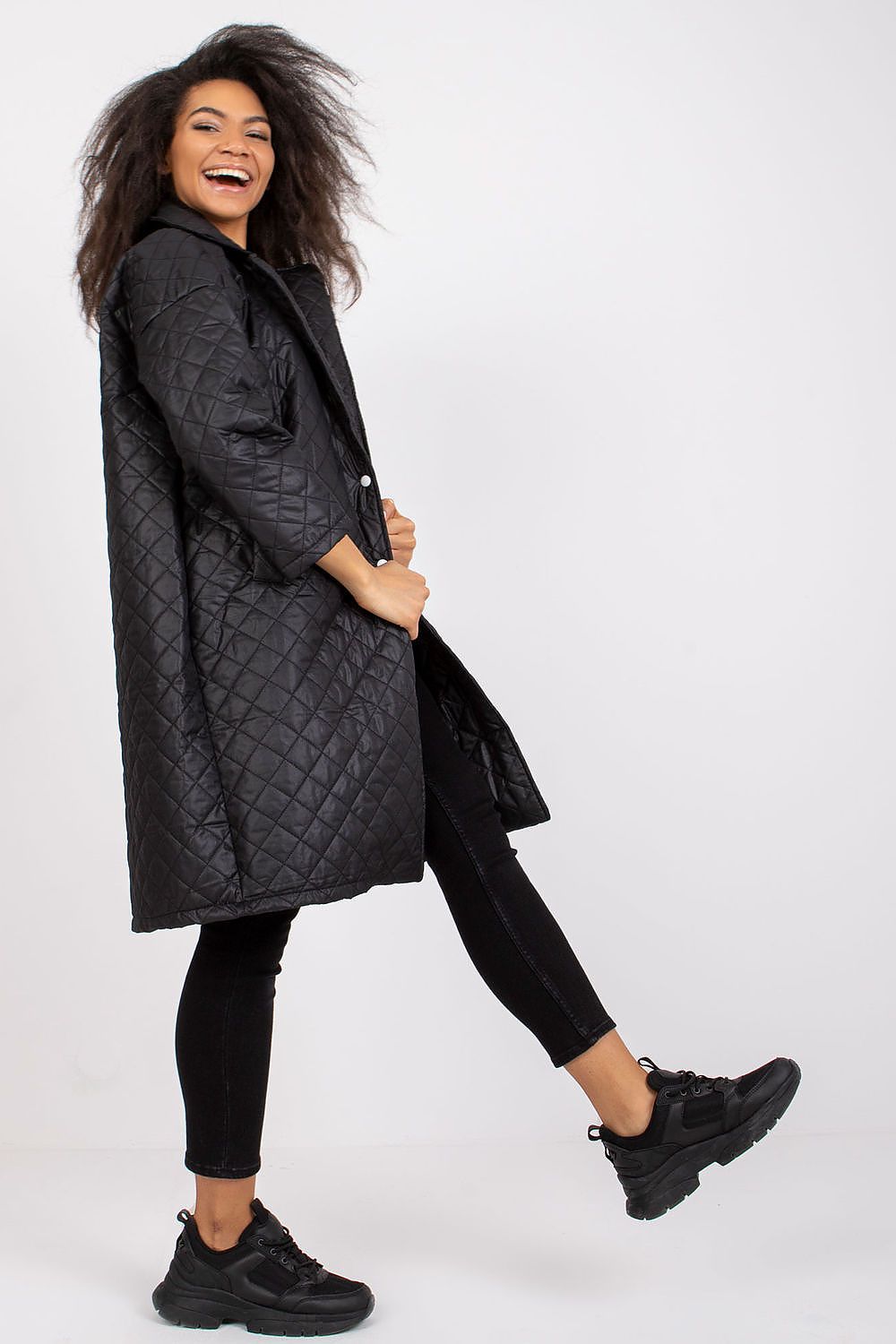 Fashionable model playfully posing in the Ex Moda Quilted Long Sleeve Coat in 100% Polyester, set against a minimalist backdrop, epitomising luxury and comfort.