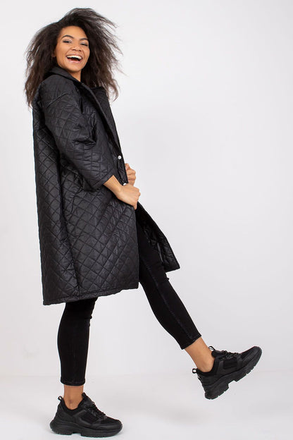 Fashionable model playfully posing in the Ex Moda Quilted Long Sleeve Coat in 100% Polyester, set against a minimalist backdrop, epitomising luxury and comfort.