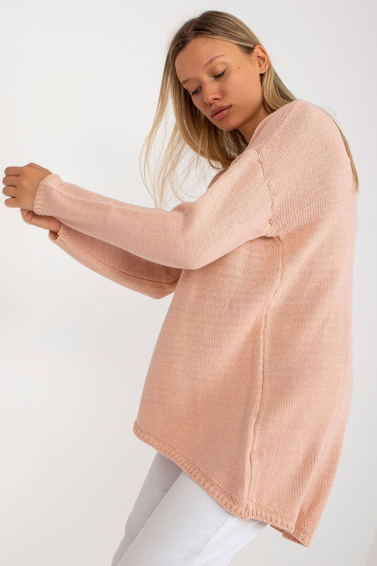 Luxury Women’s Asymmetrical Cut Sweater by Och Bella, featuring an extended length and long sleeves, in a soft pink colour, showcased by a model elegantly posing.
