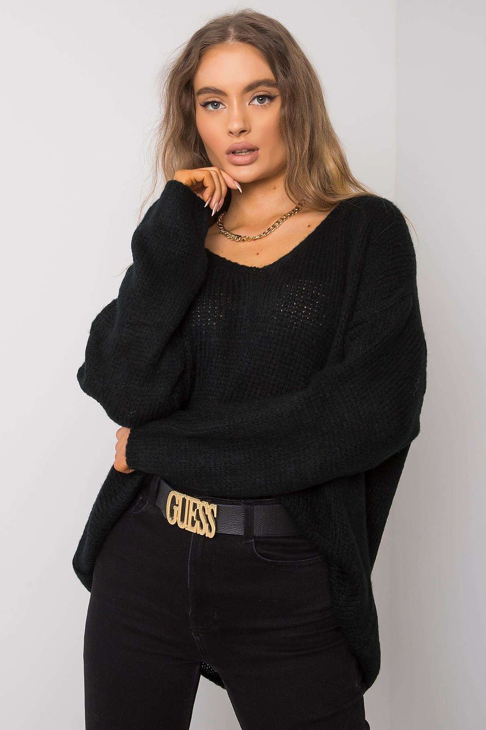 Chic Women's Och Bella Sweater in a classic black shade, designed with long sleeves and a heart neckline, presenting an asymmetrical silhouette for an upscale look.