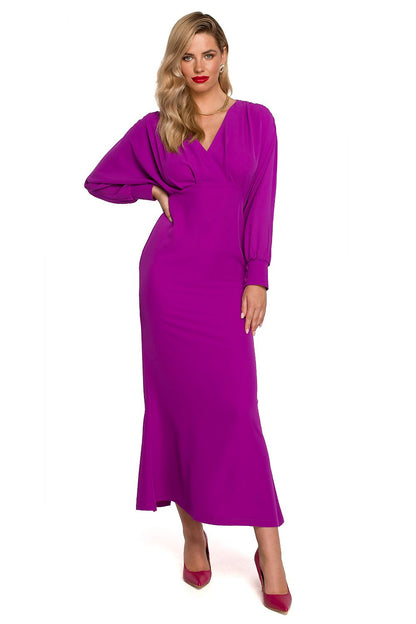 Maxi Cocktail Dress With Deep Neckline, Voluminous Sleeves And Elegant Slit By Makover, model posing confidently in a rich purple version of the dress, showcasing its opulent fabric and stylish design.