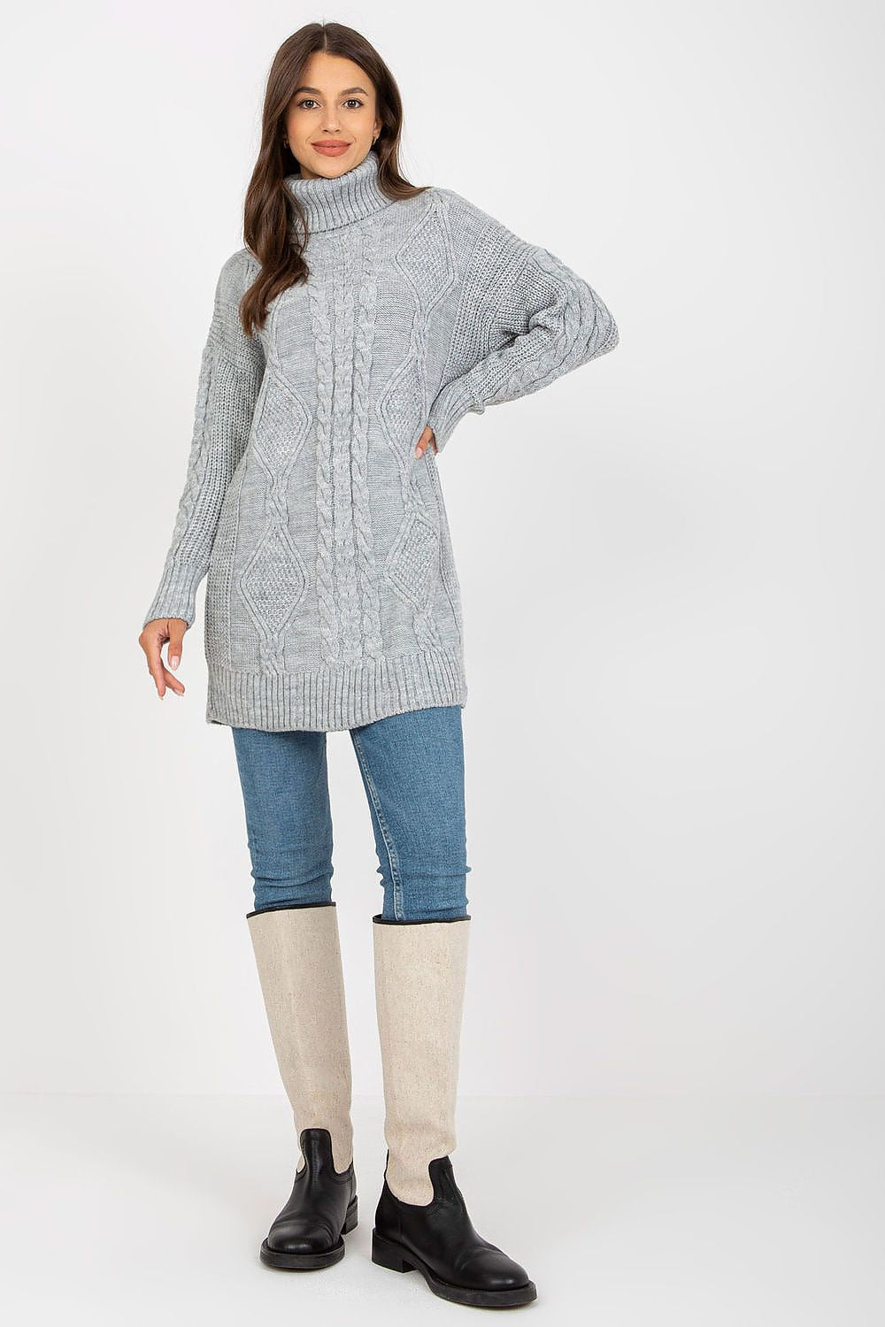 Luxurious Rue Paris Women's Long Turtleneck Jumper in soft grey acrylic and wool blend, styled with denim jeans and knee-high boots for a chic autumn look.