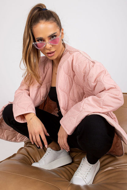 Chic Rue Paris Women's Quilted Transitional Jacket with Press Studs and Large Pockets, model casually posing with stylish sunglasses, embodying contemporary fashion in a luxurious setting.