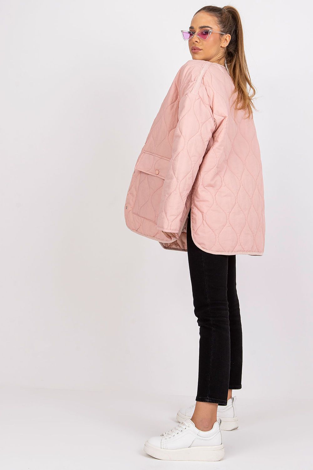 Rue Paris Women's Quilted Transitional Jacket in soft pink, styled with long sleeves and large pockets, perfect for transitional weather, showcased by a model wearing black jeans and stylish sunglasses.