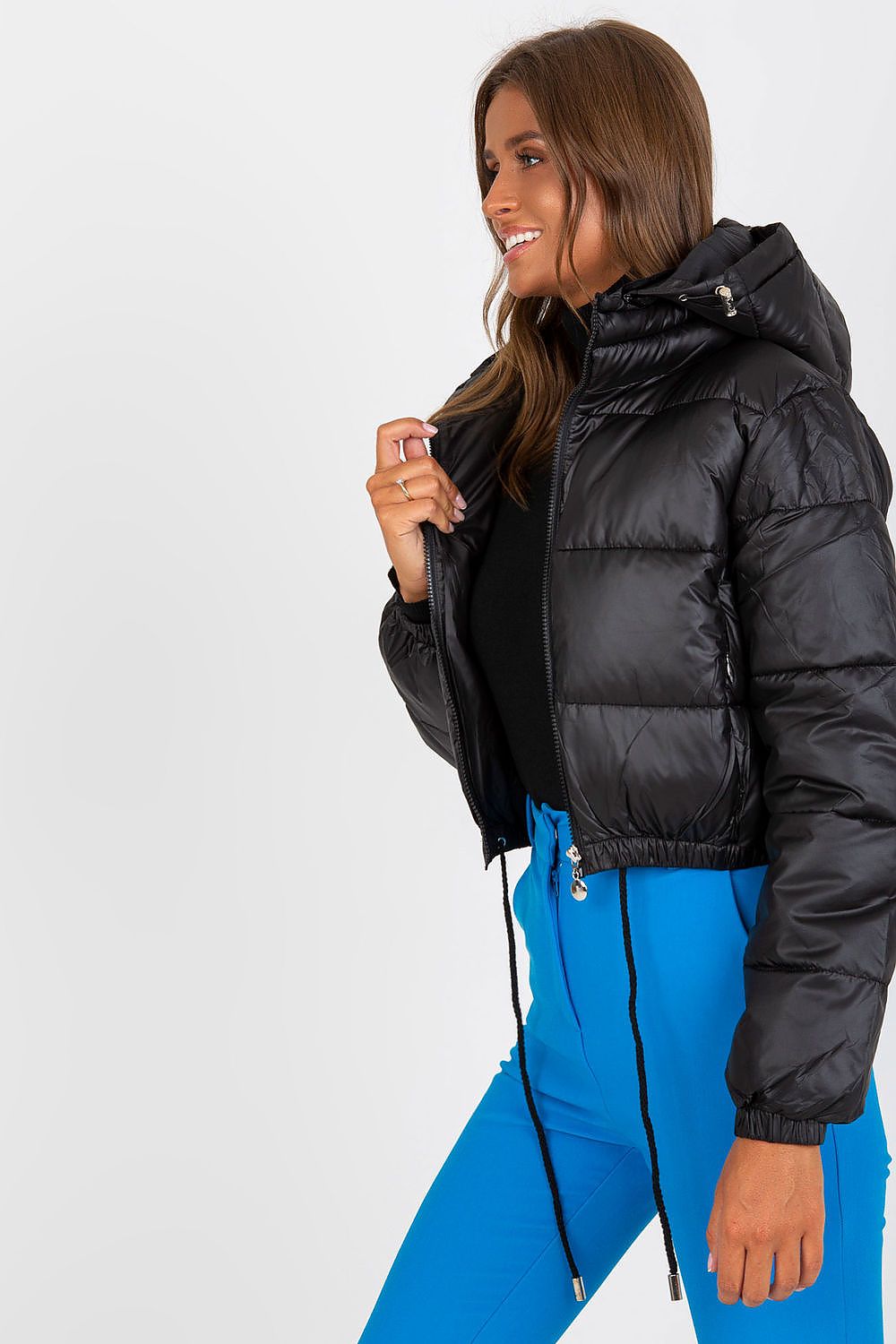 Luxury Women's Down Quilted Jacket with Detachable Hood and Zippered Pockets, displayed from the side to showcase the sleek design and modern silhouette in black.