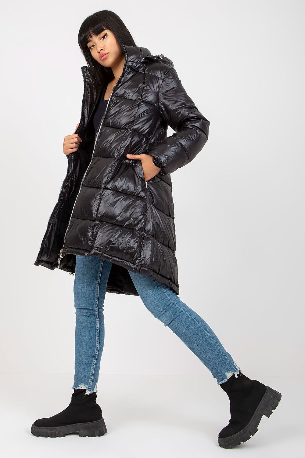 Chic Women's Quilted Nylon Coat with Detachable Hood and Zippered Pockets, model posing, exemplifying high-end outerwear elegance.