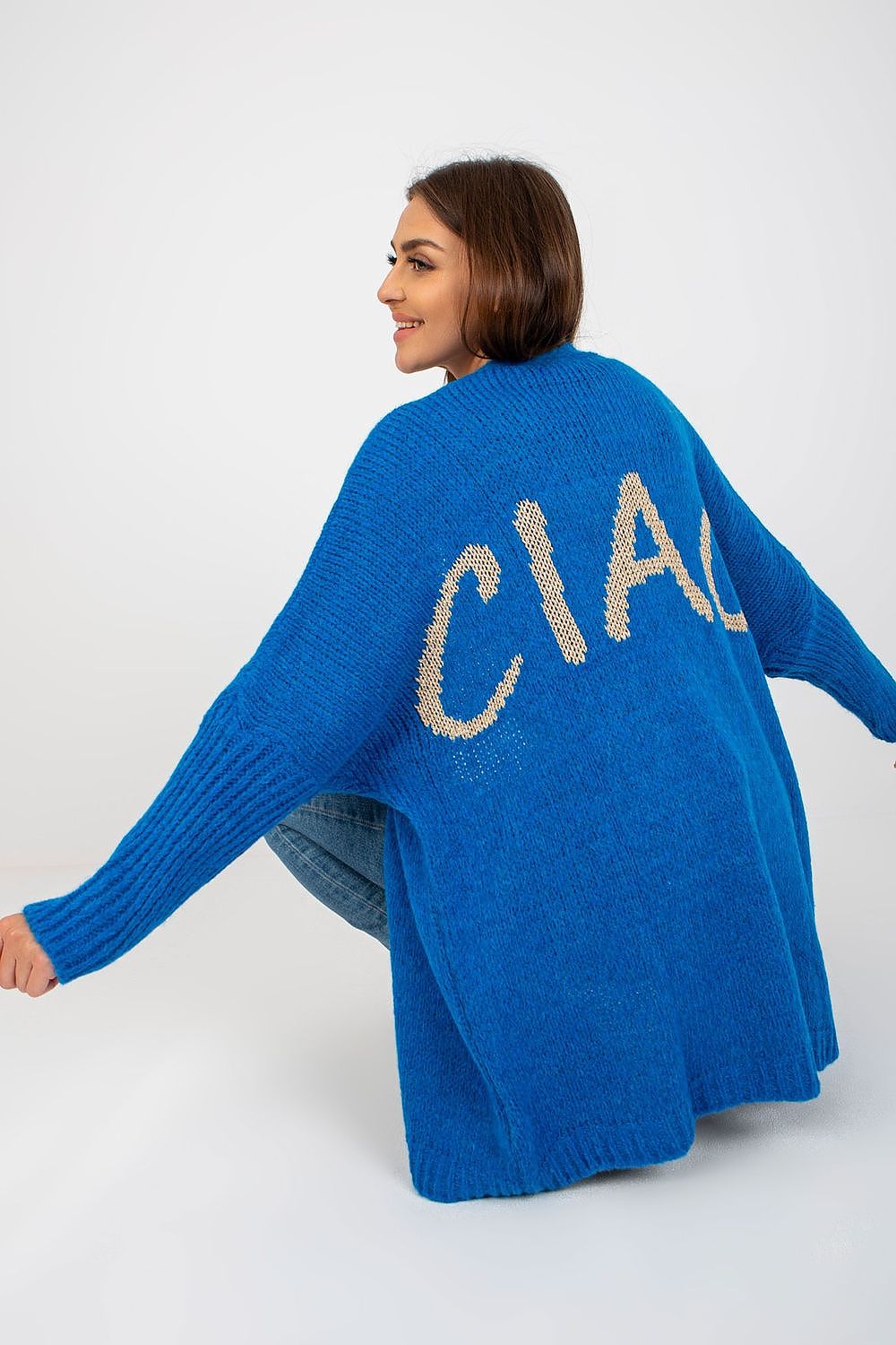 Och Bella Unbuttoned Cardigan with Long Wide Sleeves and Contrasting Lettering worn stylishly by a model, showcasing an elegant blue colour and unique ‘CIAO’ design on the back.