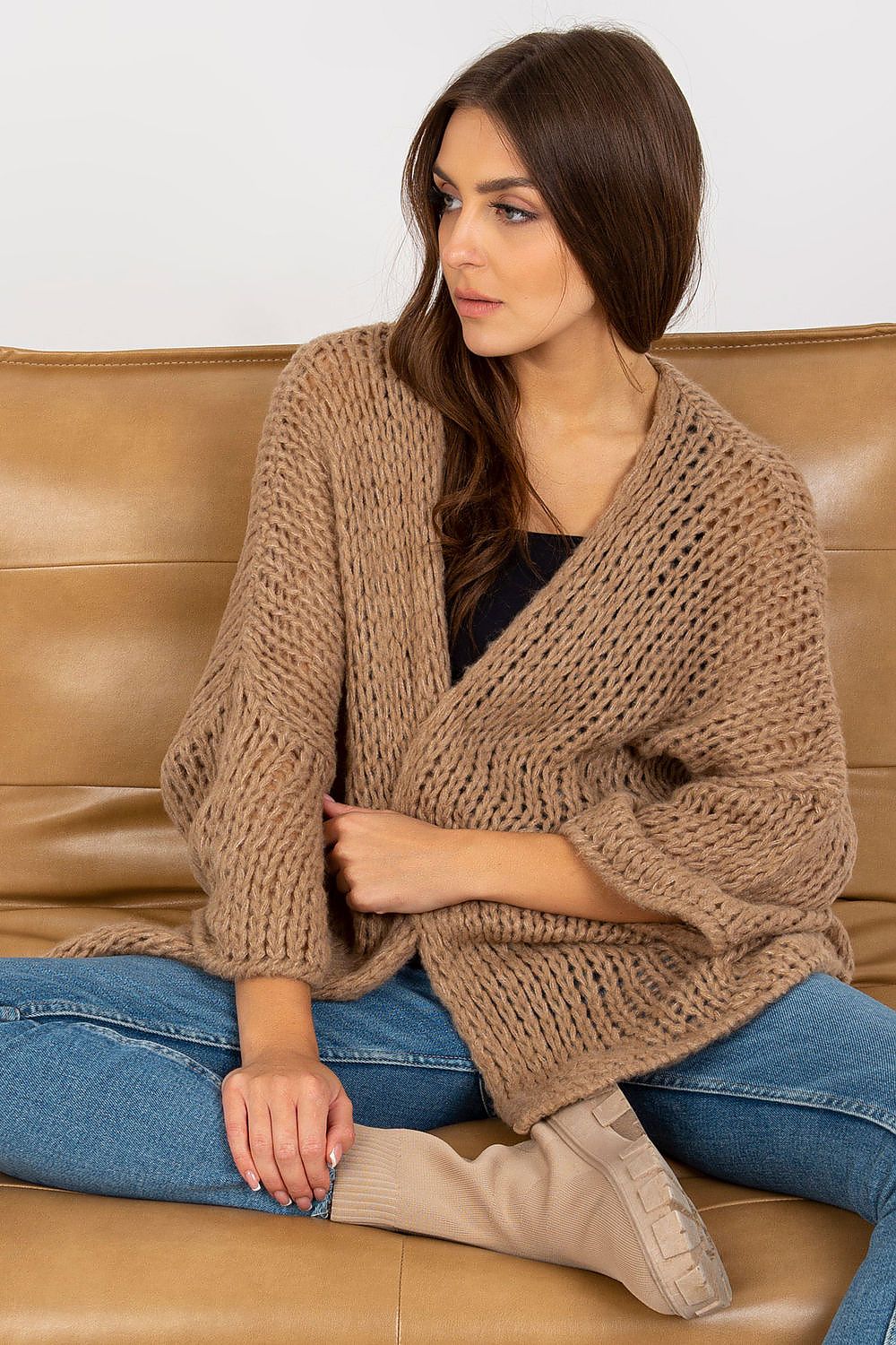 Luxury Women's Long Sleeve Cardigan by Och Bella - Soft Acrylic Blend, Elegant Design. A stylish model showcases the chic cardigan, featuring loose sleeves and an intricate knit in a warm beige shade, accentuating a sophisticated casual look.