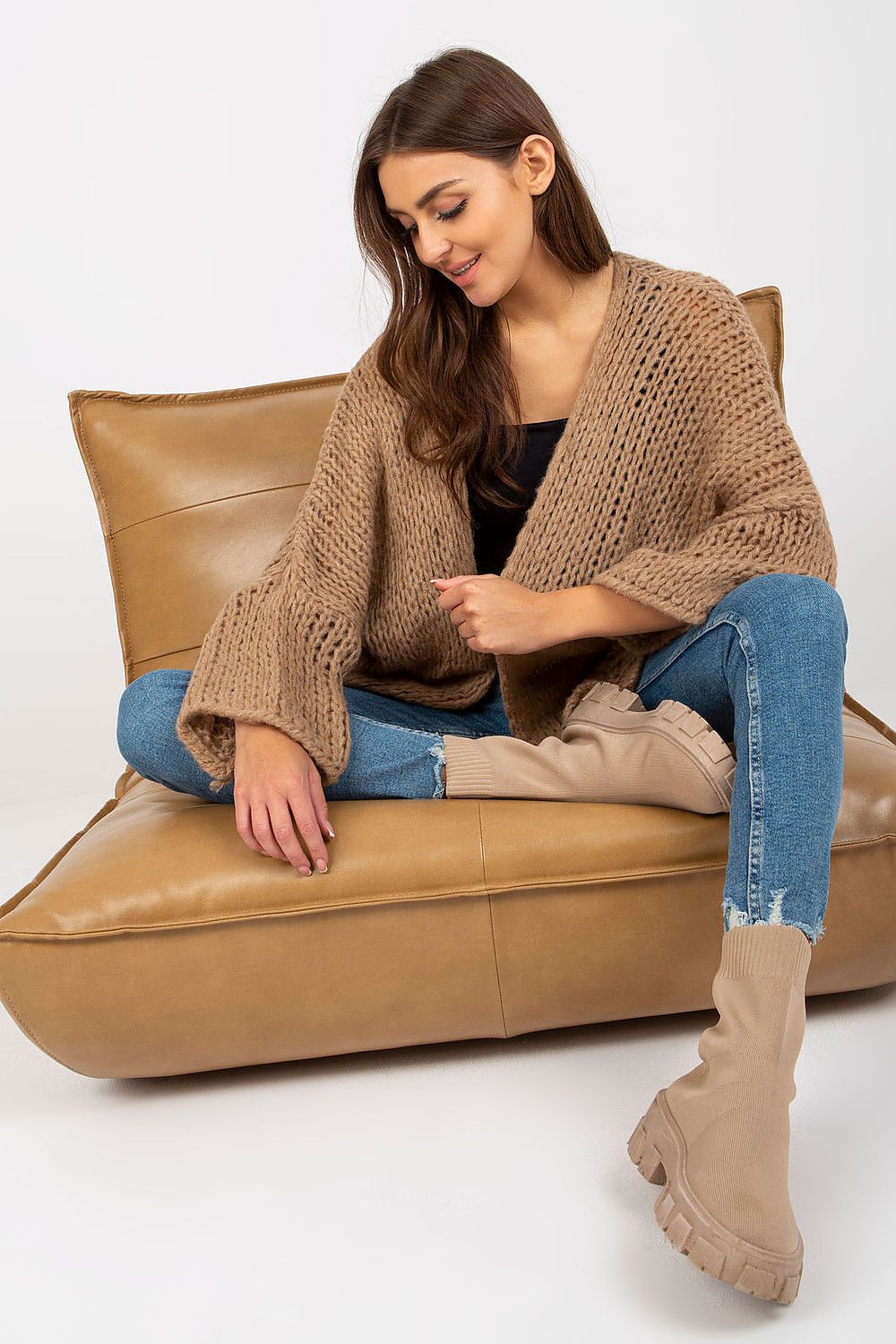 Luxury Women's Long Sleeve Cardigan by Och Bella - Soft Acrylic Blend, Elegant Design. The model elegantly poses in a fashionable beige cardigan paired with fitted jeans, highlighting the cardigan’s unique texture and laid-back sophistication.