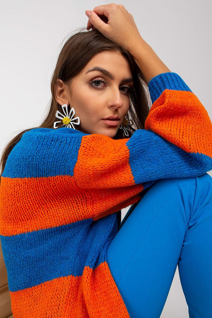 Och Bella Long Sleeve Cardigan with Colourful Stripes - Stylish, Loose Fit, EU Size 0. Model showcasing the vibrant striped cardigan in blue and orange, exuding contemporary elegance with oversized sleeves.