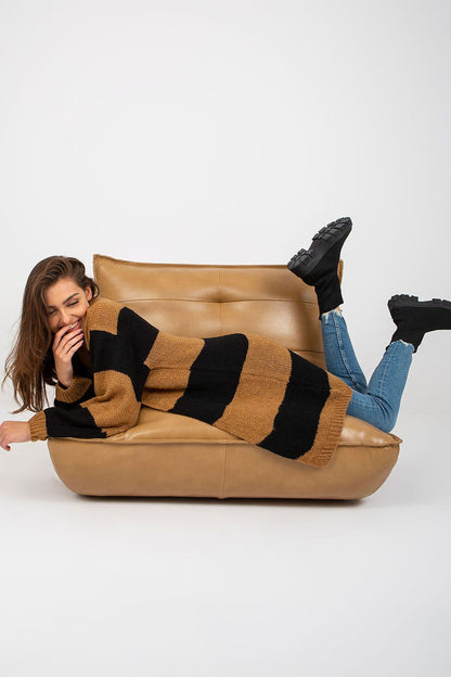 Och Bella Long Sleeve Cardigan with Colourful Stripes - Stylish, Loose Fit, EU Size 0. Model playfully lounging in a warm striped cardigan, creating a relaxed and luxurious fashion statement.