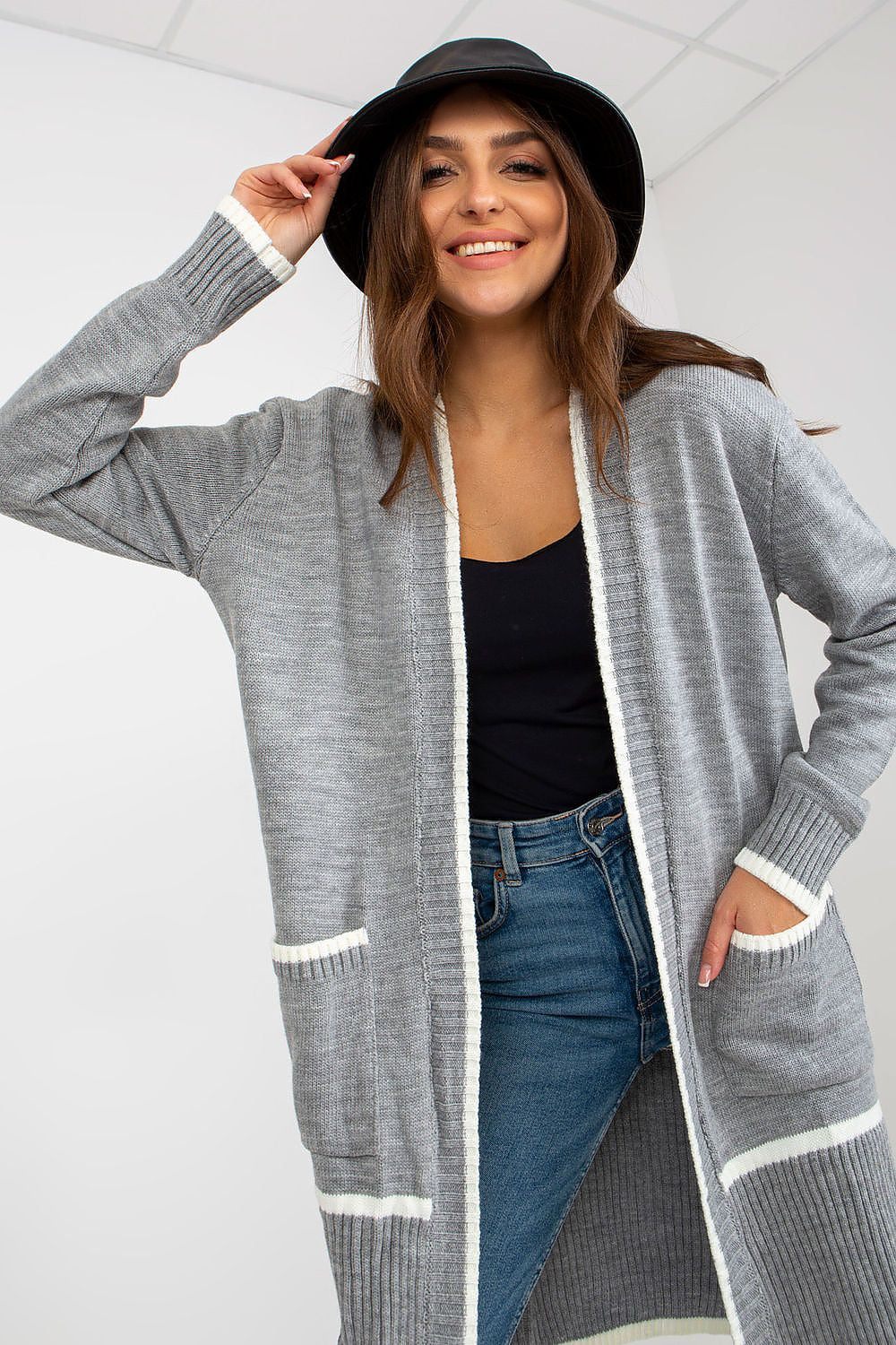 Luxury Women's Unbuttoned Long-Sleeve Cardigan with Pockets by Rue Paris, model smiling while wearing a grey cardigan with contrasting white edges over a black top, showcasing the chic unbuttoned design.