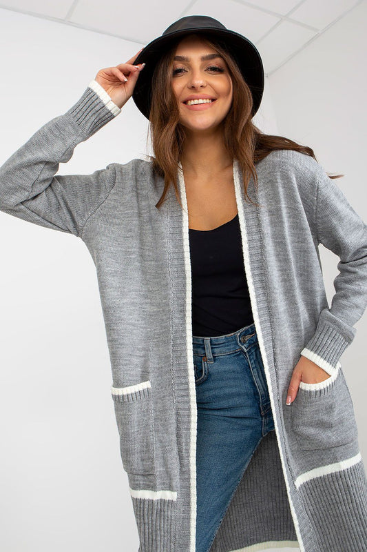 Luxury Women's Unbuttoned Long-Sleeve Cardigan with Pockets by Rue Paris, model smiling while wearing a grey cardigan with contrasting white edges over a black top, showcasing the chic unbuttoned design.