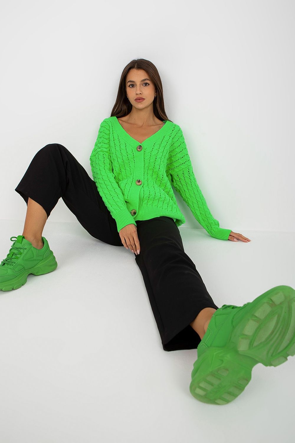 Luxury Women's 100% Acrylic Button-Down Cardigan by Rue Paris - Elegant Long Sleeve Sweater displayed on a woman seated casually, featuring a chic and trendy green cardigan.