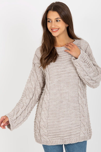 Chic Extended Cut Women's Jumper With Wide Long Sleeves in beige, presented by a smiling model highlighting the intricate cable knit design.