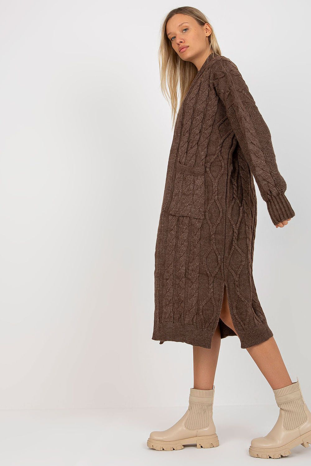 Luxury Long Sleeve No-Fastening Cardigan With Large Pockets by Rue Paris, depicted in a side view on a model, showcasing its elegant cable knit design and large front pockets.