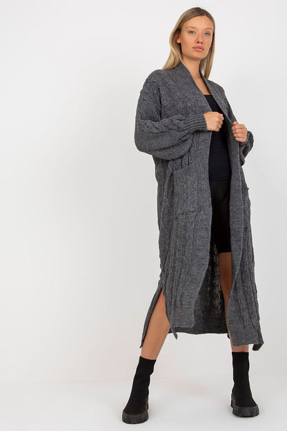 Luxury Long Sleeve No-Fastening Cardigan With Large Pockets by Rue Paris, displayed on a model in a dramatic stance, showcasing the dark grey knit fabric and sophisticated side slits.
