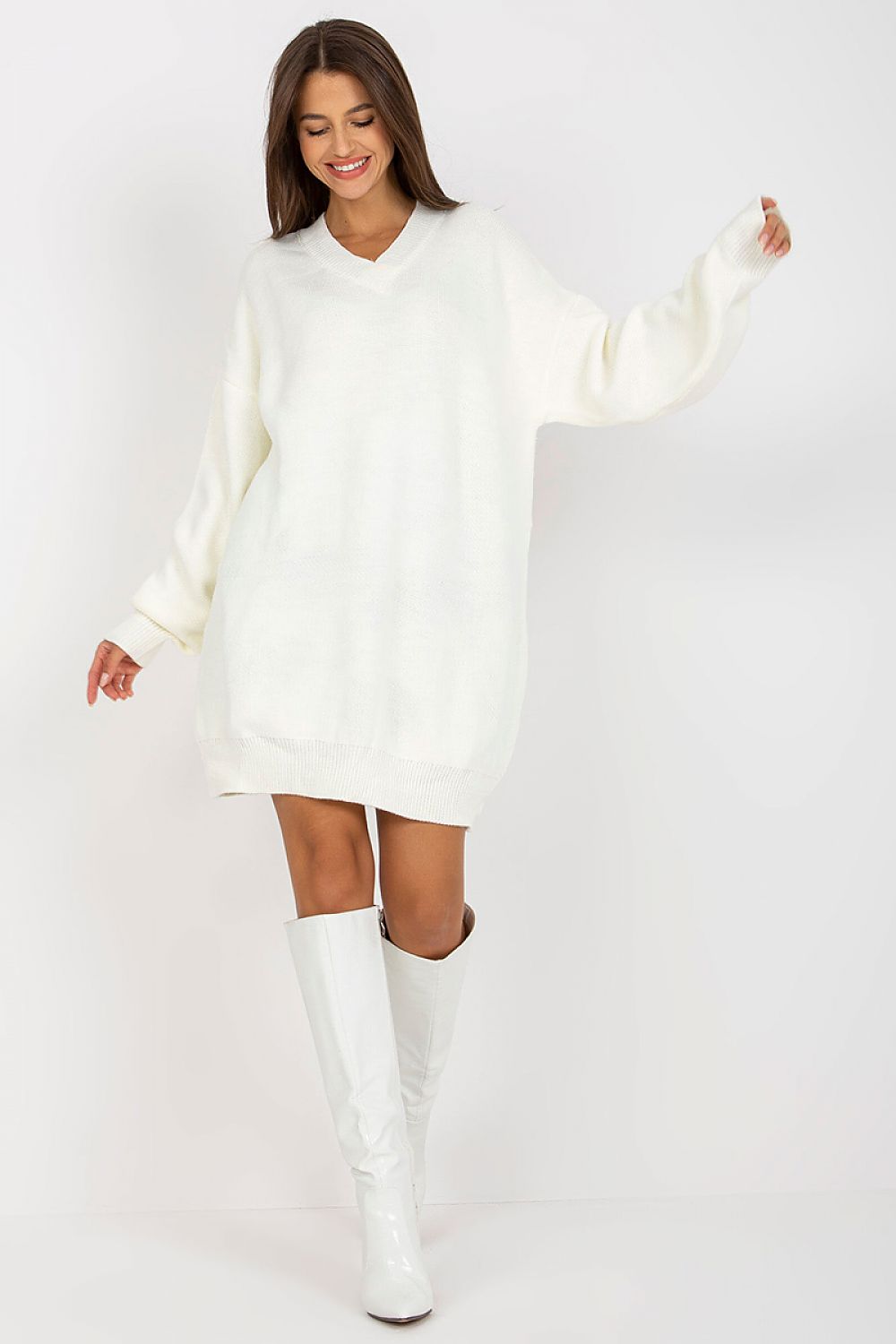 Luxurious Rue Paris Women's Sweater with Extended Cut, Long Sleeves and Heart Neckline in chic white, elegantly paired with stylish white boots.