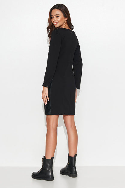 Close-up of the Numinou black short dress, showcasing the exquisite leather texture and knitted fabric, perfectly combining luxury and ease for every occasion.