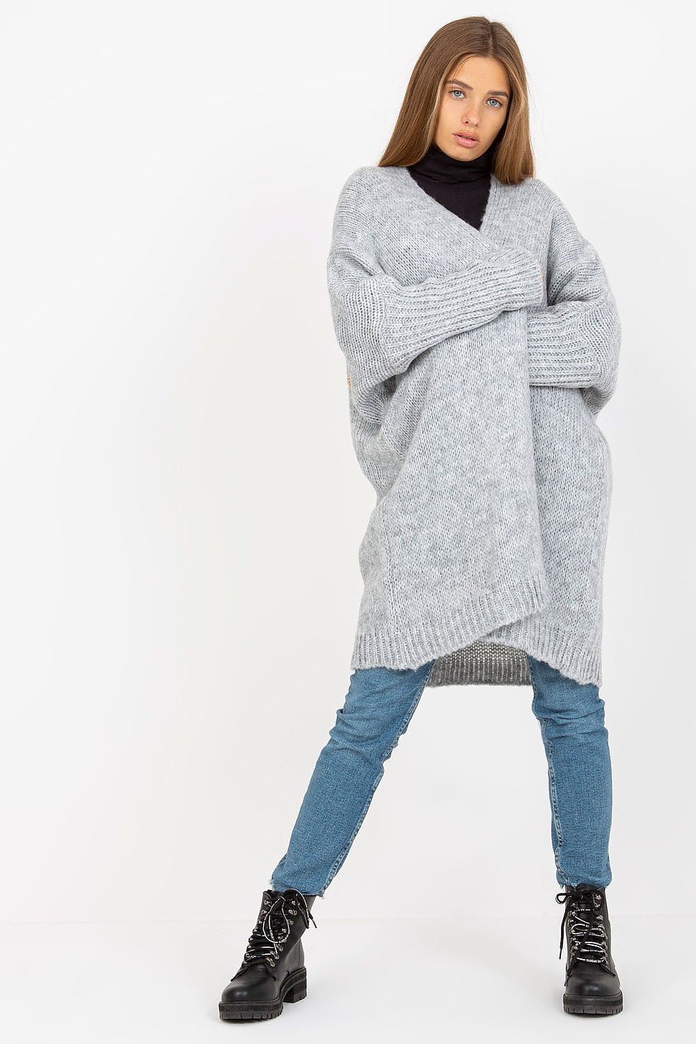 Och Bella Unbuttoned Cardigan with Long Wide Sleeves and Contrasting Lettering, showcased in a light grey hue, worn over a sleek black turtleneck, paired with fitted denim jeans and stylish combat boots, exuding a luxurious casual look.