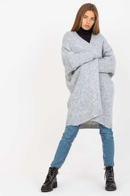 Och Bella Unbuttoned Cardigan with Long Wide Sleeves and Contrasting Lettering, showcased in a light grey hue, worn over a sleek black turtleneck, paired with fitted denim jeans and stylish combat boots, exuding a luxurious casual look.