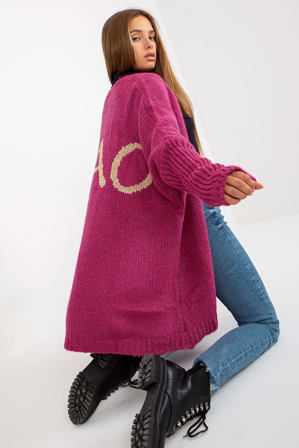 Och Bella Unbuttoned Cardigan with Long Wide Sleeves and Contrasting Lettering in a rich pink shade, emphasizing the playful 'CIAO' detail on the back, perfectly styled with fitted jeans and elegant boots for a sophisticated ensemble.
