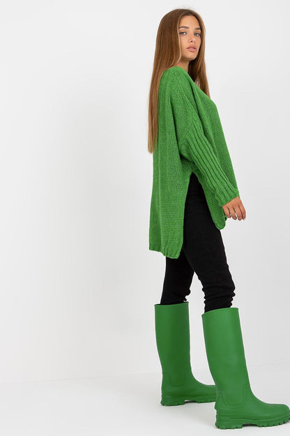 Engaging profile of a model in the Stylish Women's Loose Fit Sweater by Och Bella, featuring side slits, paired with vivid green rubber boots for a contemporary look.