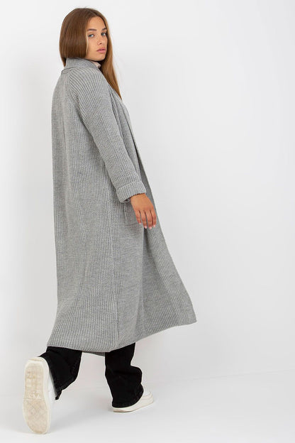 Back view of the Elegant Long Unbuttoned Cardigan by Och Bella, emphasising the luxurious fabric and long silhouette, complemented by chic black flared trousers.