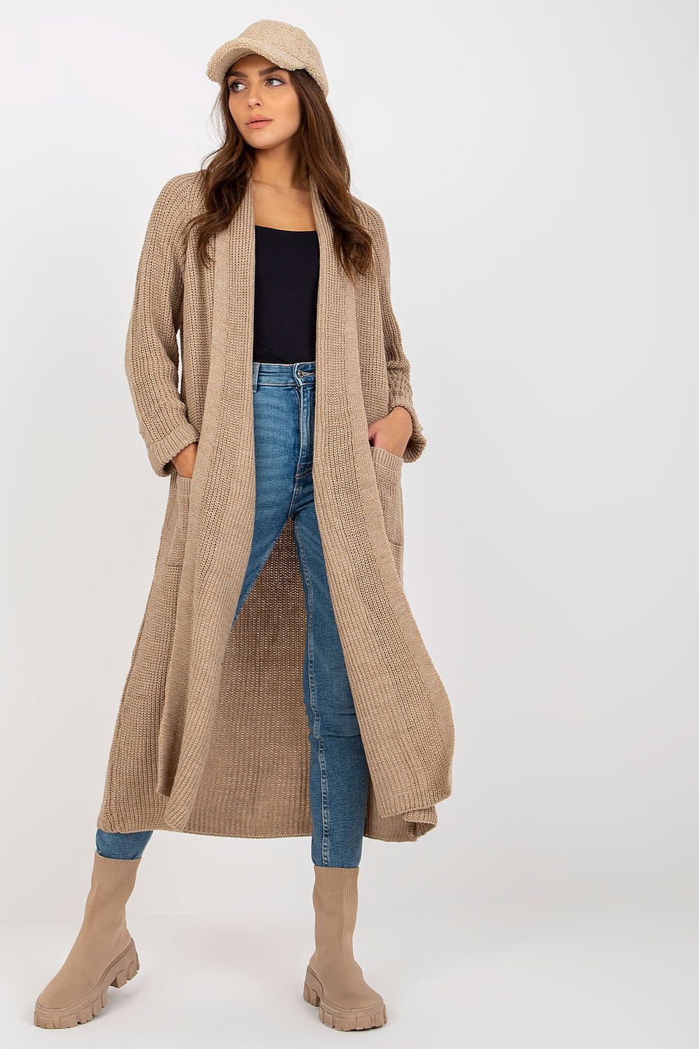 Elegant Long Unbuttoned Cardigan by Och Bella, crafted from 70% Acrylic and 30% Wool, featuring slip pockets, showcased stylishly with a model wearing chic denim and trendy footwear.