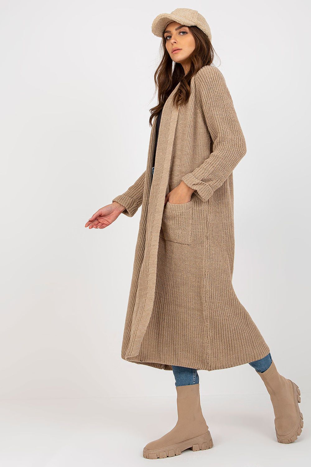 Elegant Long Unbuttoned Cardigan by Och Bella, designed with slip pockets, displayed on a model in a sophisticated side view, accentuating its luxurious fabric blend of 70% Acrylic and 30% Wool.