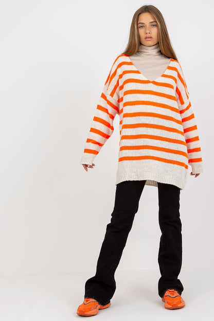 Och Bella Women's Colourful Striped Sweater with Long Sleeves and V-Neck Design, presented in a fashion-forward outfit with relaxed black trousers and bright orange sneakers, highlighting a contemporary and luxurious appeal.