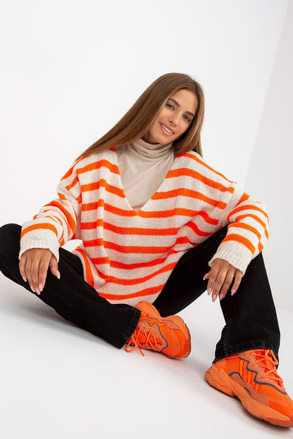 Och Bella Women's Colourful Striped Sweater with Long Sleeves and V-Neck Design, featuring vibrant orange stripes being modelled casually with black pants and vibrant sneakers.