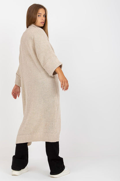 Back view of Luxury 3/4 Sleeve Long Unbuttoned Cardigan by Och Bella with Slip Pockets in Acrylic and Wool Blend, showcasing the relaxed fit and luxurious texture, styled with black trousers.