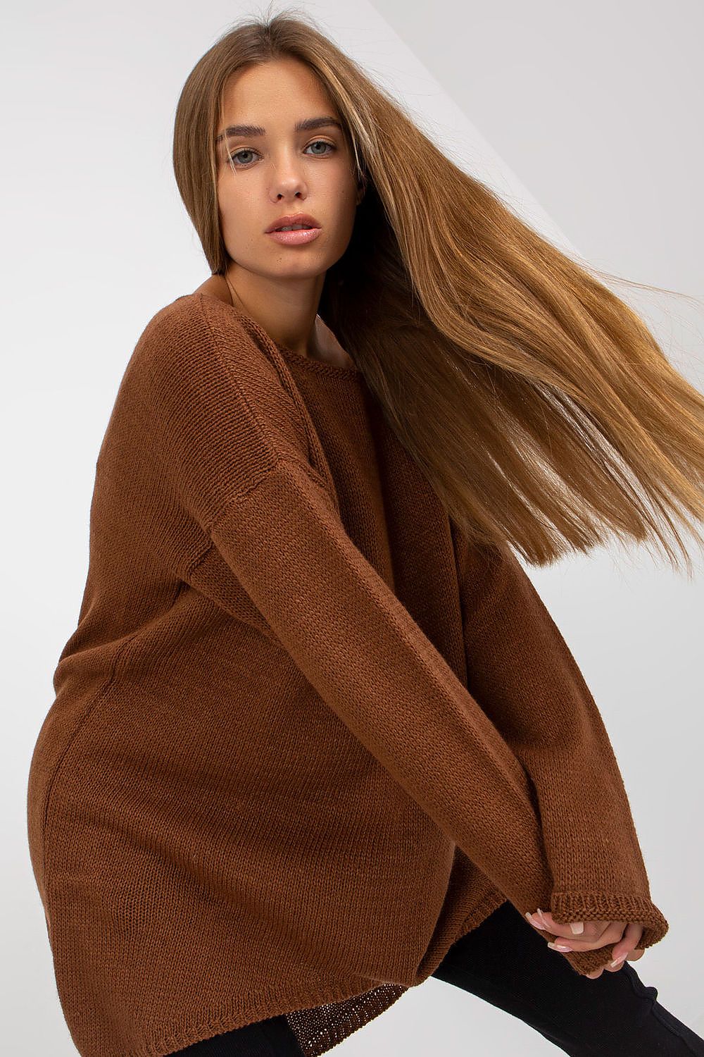 Luxury Women’s Asymmetrical Cut Sweater by Och Bella, model with long brown hair wearing a brown asymmetrical sweater featuring long sleeves, showcasing a stylish and relaxed fit.