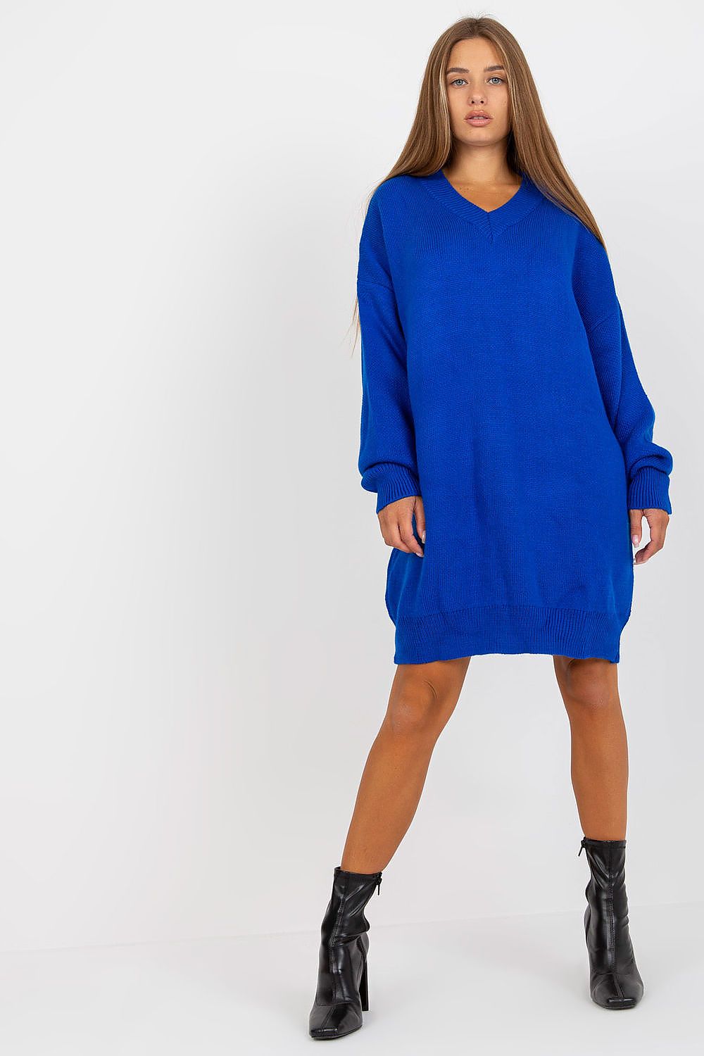 Luxurious Rue Paris Women's Sweater with Extended Cut, Long Sleeves and Heart Neckline in striking blue, complemented with trendy black ankle boots.