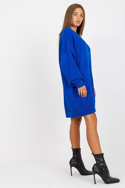 Luxurious Rue Paris Women's Sweater with Extended Cut, Long Sleeves and Heart Neckline in bold blue, featured from a side angle with fashionable black ankle boots.