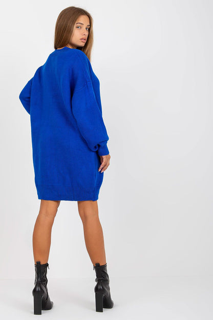 Luxurious Rue Paris Women's Sweater with Extended Cut, Long Sleeves and Heart Neckline showcased on a model from the back, featuring a vibrant blue colour and paired with stylish black ankle boots.