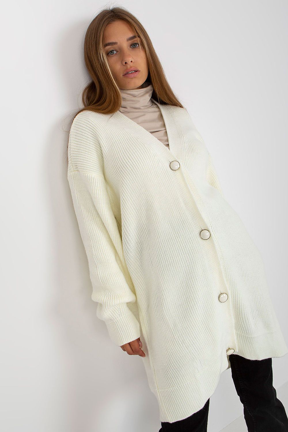 Elegant Extended Cut Cardigan by Rue Paris in ivory, featuring a button closure and long sleeves, styled with a fitted turtleneck for a sophisticated look.