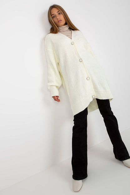 Elegant Extended Cut Cardigan by Rue Paris displayed in white, showcasing a relaxed fit with a button closure, long sleeves, paired with a stylish turtleneck.