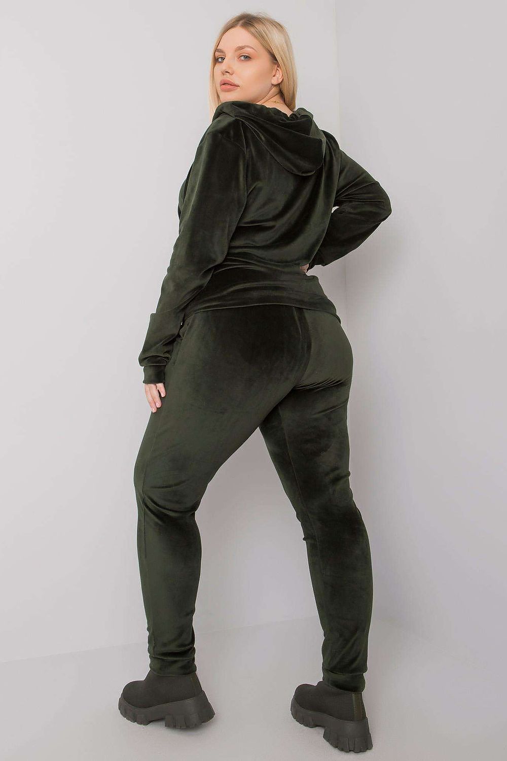 Luxurious Plus Size Velour Set: Zip-Up Hoodie and Tie-Waist Pants for Ultimate Comfort, presented by a model in a flattering green velour set, highlighting the tie-waist design for a modern twist.