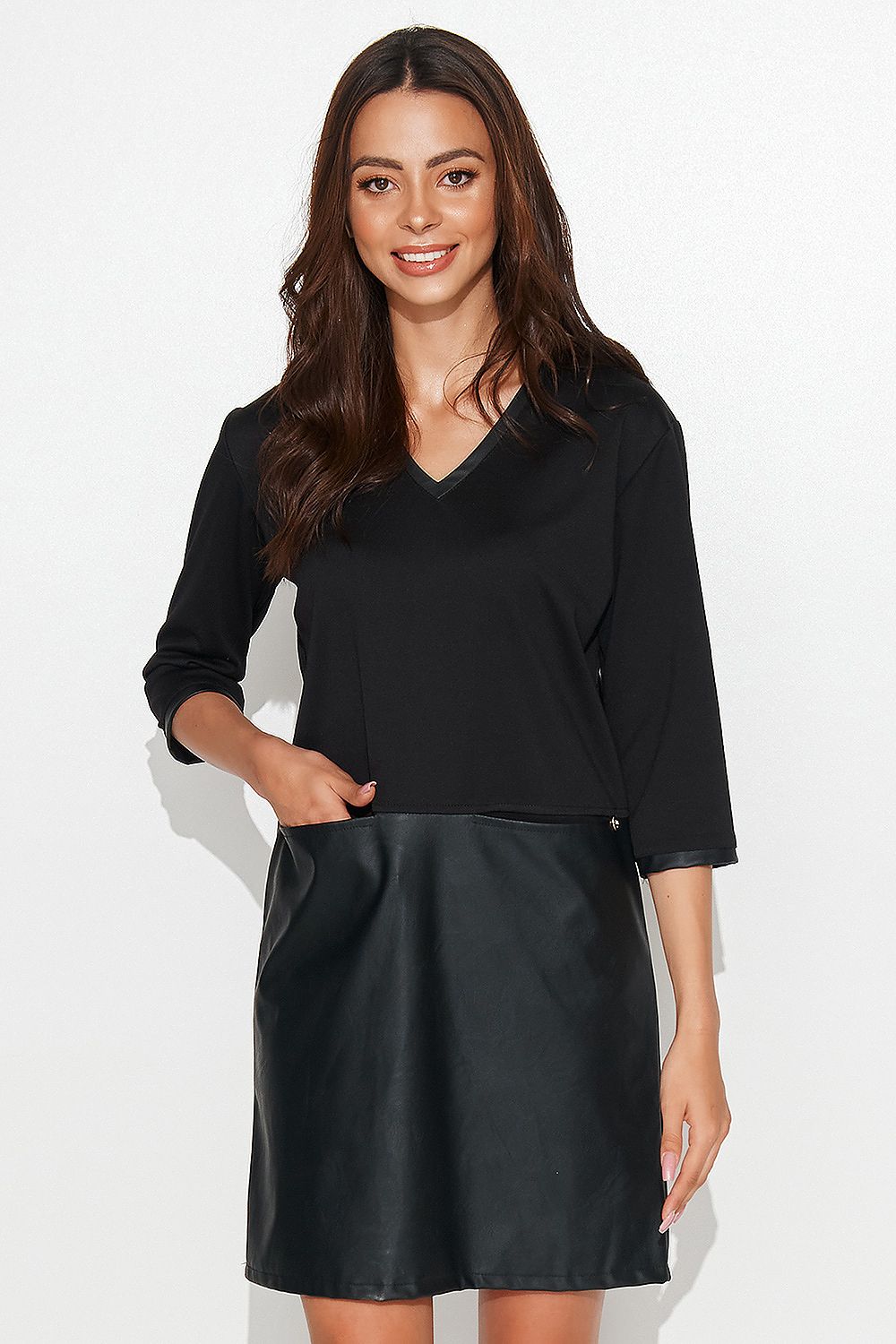 Elegant black casual knit dress by Numinou featuring eco leather details and stylish decorative pockets, perfect for sophisticated occasions.