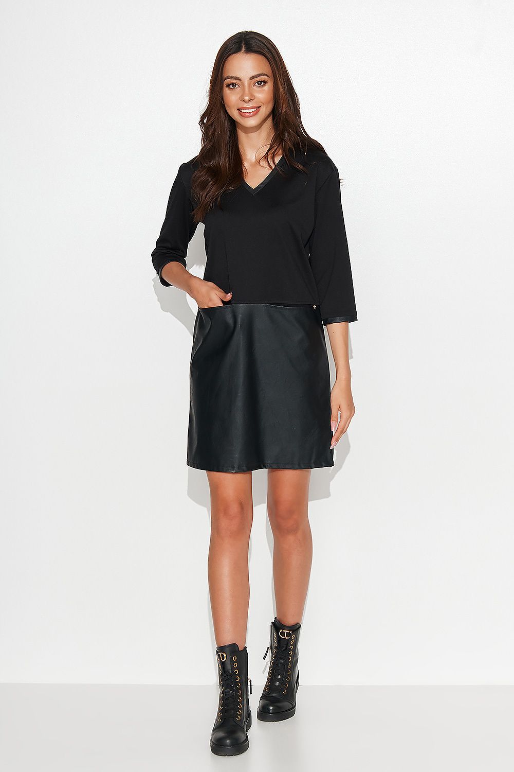 Close-up view of the eco leather trimmed neckline and sleeve of the black casual knit dress by Numinou, showcasing luxury craftsmanship.