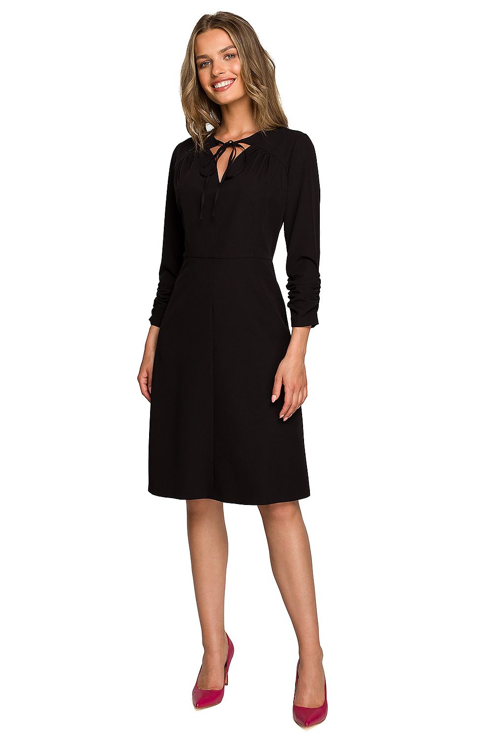 Sophisticated black daydress with a flattering silhouette, elegantly adorned by a model, ideal for upscale events.