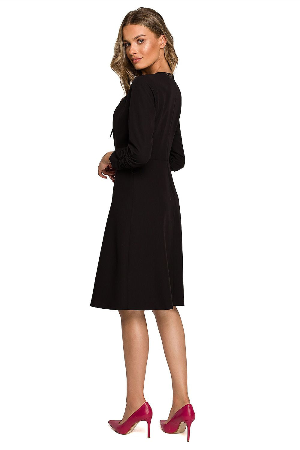 Stylish black daydress with ruffled sleeves and tie-neck detail, presented on a model showcasing luxury and elegance.