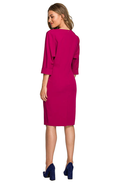 Back view of a stylish women's daydress in vibrant fuchsia with elegant batwing sleeves and a feminine waist cut, perfect for chic outings.
