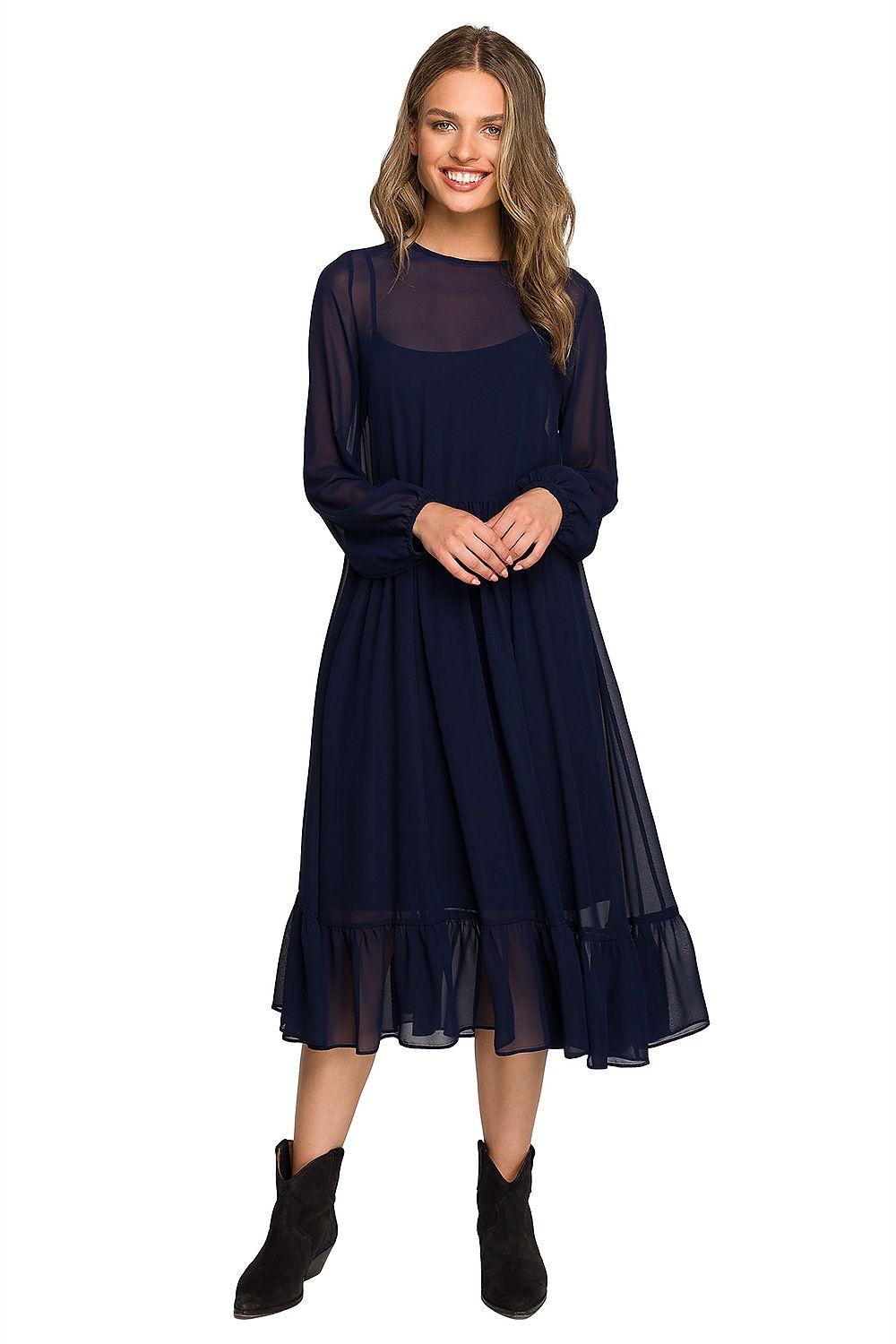 Stylish woman in a navy chiffon cocktail dress with ruffled waistline and wide elastic sleeves, standing confidently in an elegant pose, perfect for evening wear.