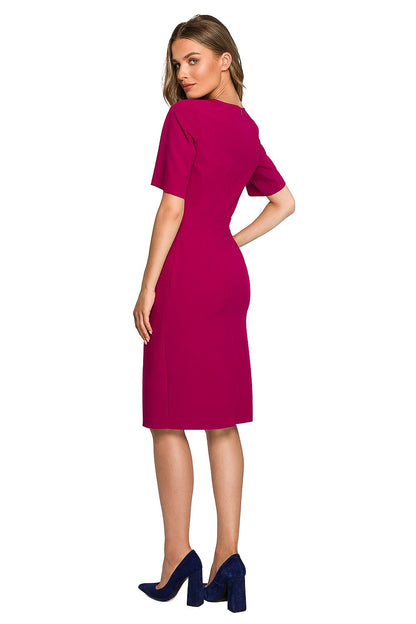 Stylish woman wearing a fuchsia Elegant Pencil Dress with a double overlap front, showcasing a flattering silhouette, complemented by navy high heels, epitomising modern elegance.